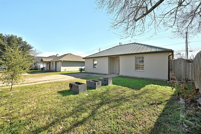 rear view of property with a yard