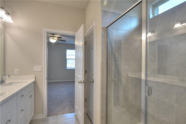 bathroom featuring ceiling fan, a wealth of natural light, a shower with shower door, and vanity