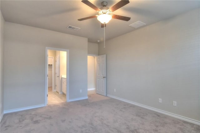 unfurnished bedroom with ceiling fan, light carpet, and connected bathroom