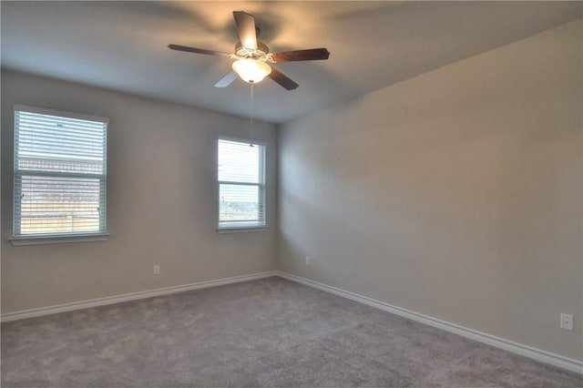 unfurnished room with ceiling fan and carpet flooring