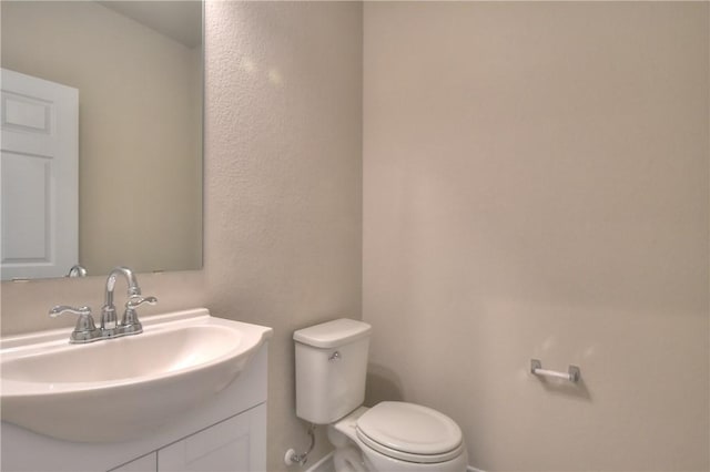 bathroom with toilet and vanity