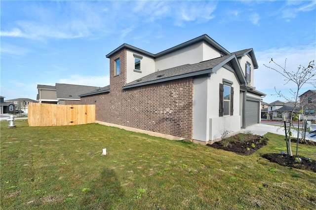 view of side of property featuring a yard and a garage