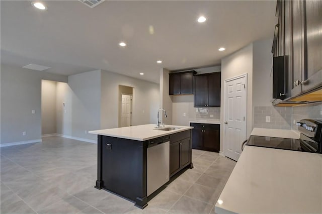 kitchen featuring stainless steel dishwasher, sink, electric range, and an island with sink