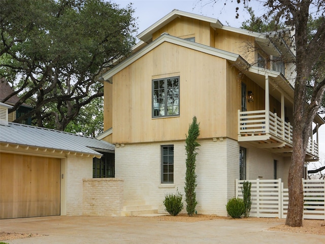 view of side of home with a balcony