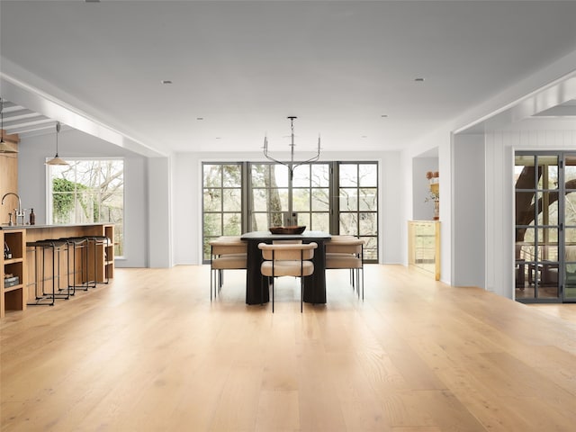 dining space with light hardwood / wood-style flooring and sink