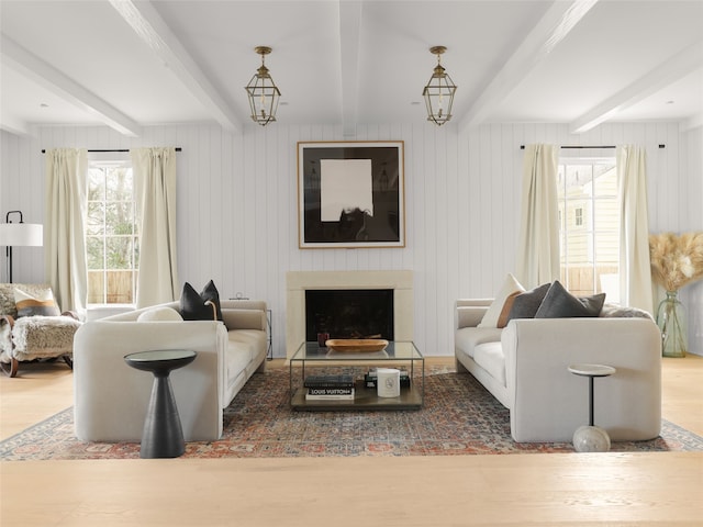 living room with beam ceiling, a notable chandelier, dark hardwood / wood-style flooring, and wood walls