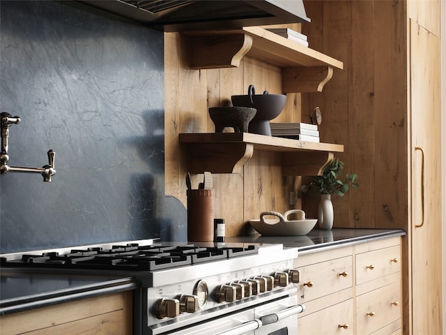 kitchen featuring range with two ovens and light brown cabinets