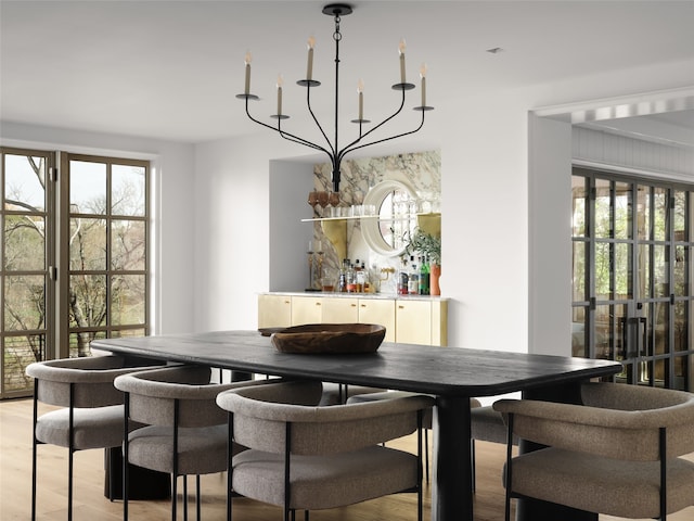 dining area featuring light wood-type flooring and a chandelier