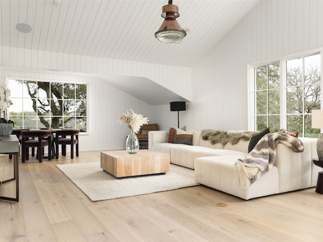 living room featuring lofted ceiling, light hardwood / wood-style flooring, and wooden walls