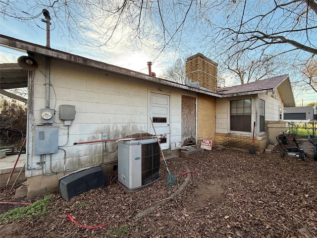 back of property featuring central AC