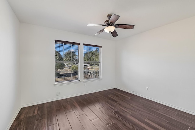 unfurnished room with dark wood-type flooring and ceiling fan