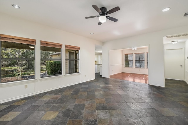 unfurnished living room featuring ceiling fan