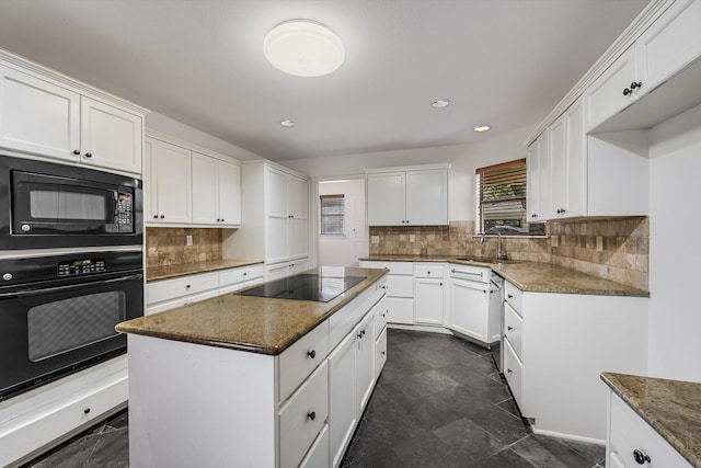 kitchen featuring white cabinetry, dark stone countertops, a center island, tasteful backsplash, and black appliances