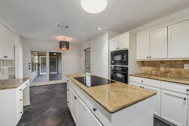 kitchen featuring pendant lighting, white cabinets, decorative backsplash, and black appliances