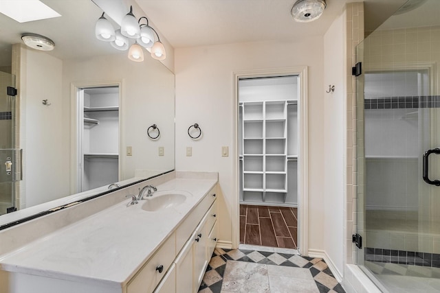 bathroom featuring vanity and an enclosed shower