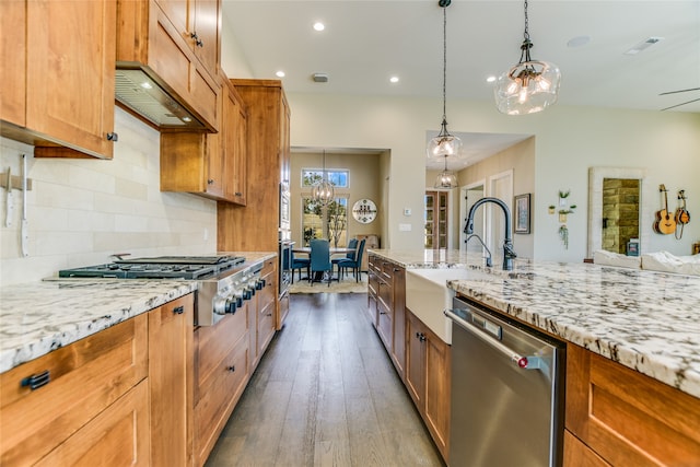 kitchen featuring appliances with stainless steel finishes, decorative backsplash, sink, hanging light fixtures, and dark hardwood / wood-style floors