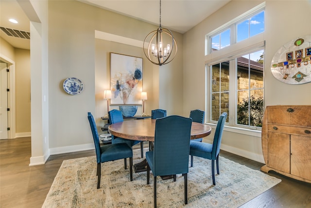 dining room featuring dark hardwood / wood-style flooring and an inviting chandelier