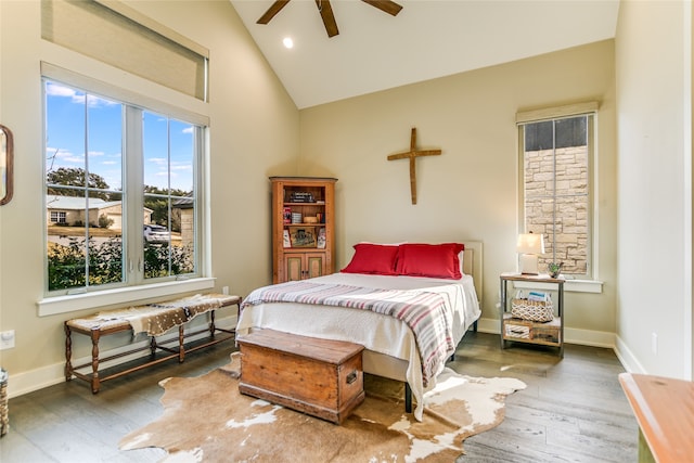 bedroom with ceiling fan, dark hardwood / wood-style floors, and high vaulted ceiling