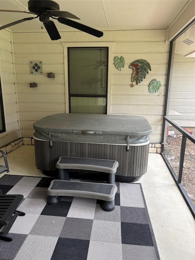 view of patio / terrace with ceiling fan and a hot tub