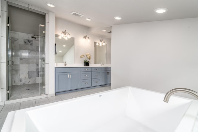 bathroom featuring a shower with shower door and vanity