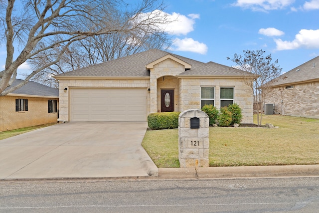 ranch-style house with central AC, a front lawn, and a garage