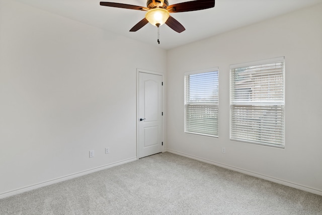 unfurnished room with ceiling fan and light colored carpet