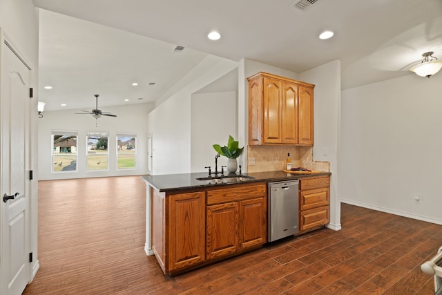 kitchen featuring ceiling fan, decorative backsplash, dark wood-type flooring, dishwasher, and sink