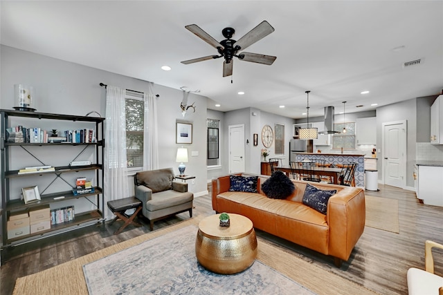 living room with ceiling fan and hardwood / wood-style flooring