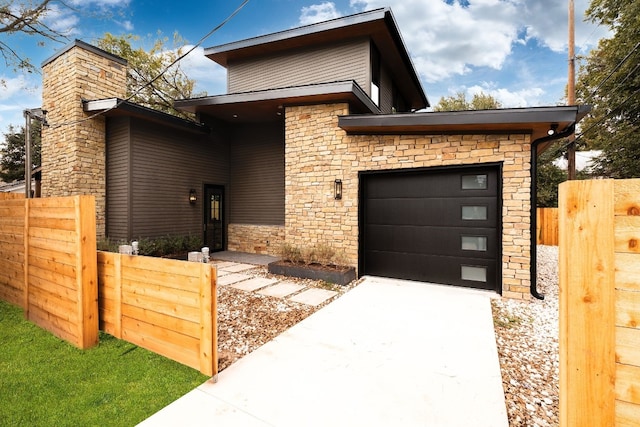1808 Riverview St Unit B, Austin, TX 78702 - contemporary home with stone siding, a garage, and driveway