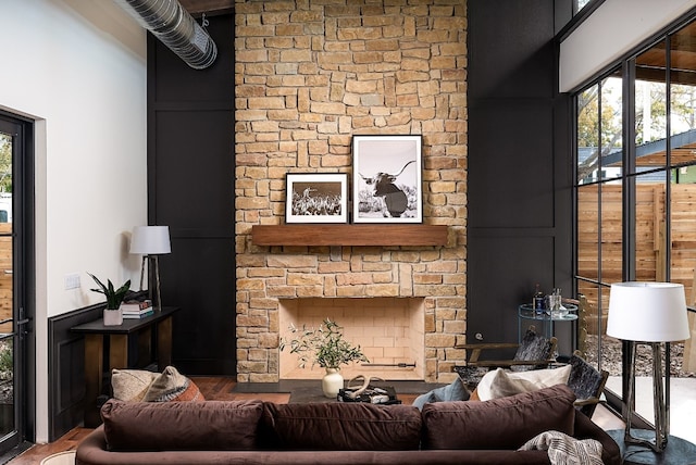 1808 Riverview St Unit B, Austin, TX 78702 - living area with a stone fireplace, wood finished floors, plenty of natural light, and a high ceiling