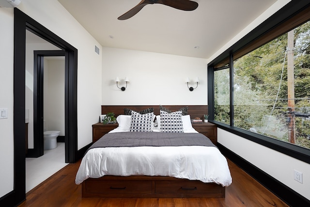 bedroom featuring ceiling fan, ensuite bathroom, and hardwood / wood-style flooring