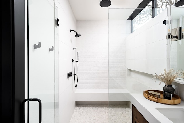 bathroom featuring an enclosed shower and vanity