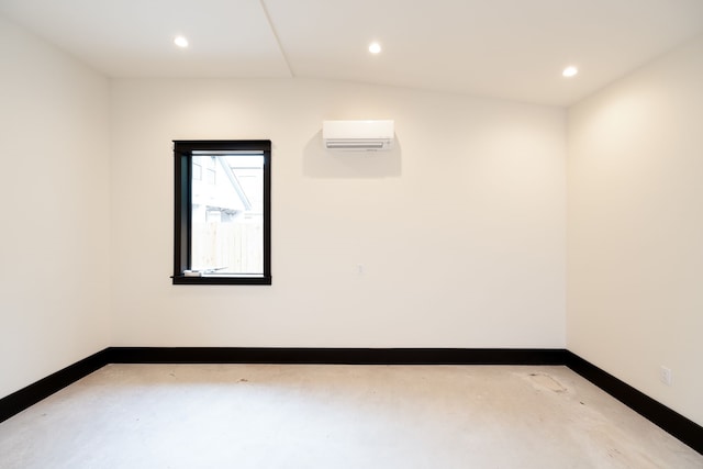 spare room featuring lofted ceiling and a wall mounted AC