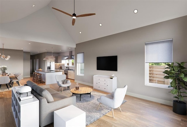 living room featuring high vaulted ceiling, a healthy amount of sunlight, ceiling fan with notable chandelier, and light hardwood / wood-style floors