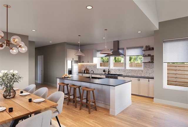 kitchen featuring white cabinets, a kitchen island, island exhaust hood, hanging light fixtures, and stainless steel fridge