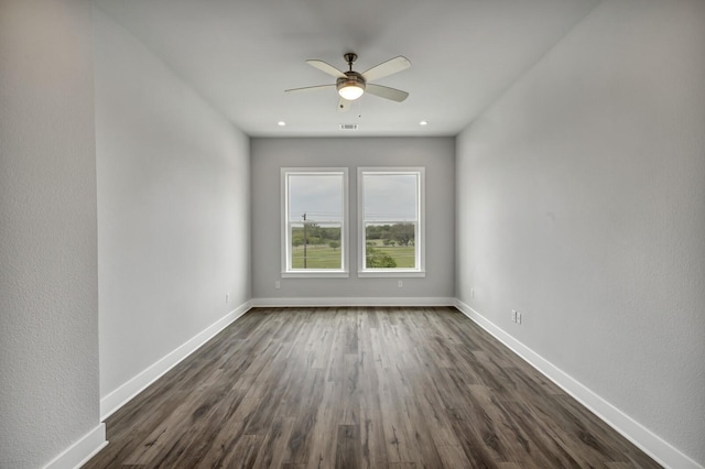 empty room featuring ceiling fan and dark wood-type flooring