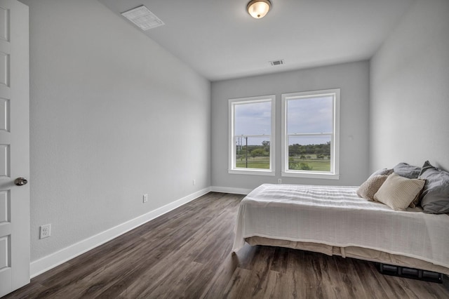 bedroom with dark hardwood / wood-style floors