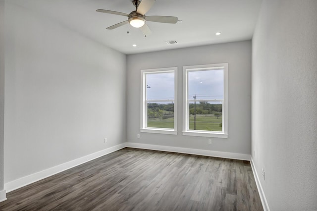 spare room with ceiling fan and hardwood / wood-style flooring