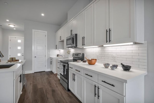 4507 E Martin Luther King Jr Blvd Unit 124, Austin, TX 78721 - kitchen featuring stainless steel appliances, decorative backsplash, white cabinets, light countertops, and dark wood-style flooring