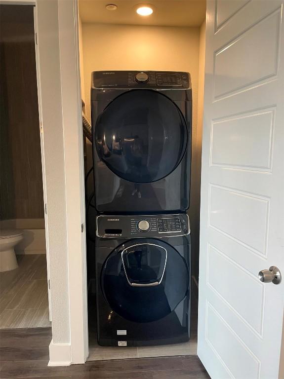 4507 E Martin Luther King Jr Blvd Unit 124, Austin, TX 78721 - laundry room with estacked washer and dryer and wood finished floors