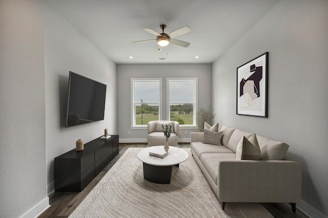 4507 E Martin Luther King Jr Blvd Unit 124, Austin, TX 78721 - living room featuring baseboards, a ceiling fan, and wood finished floors