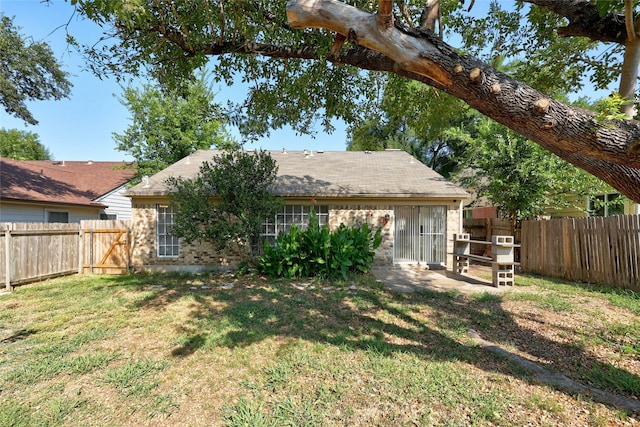 rear view of property with a yard