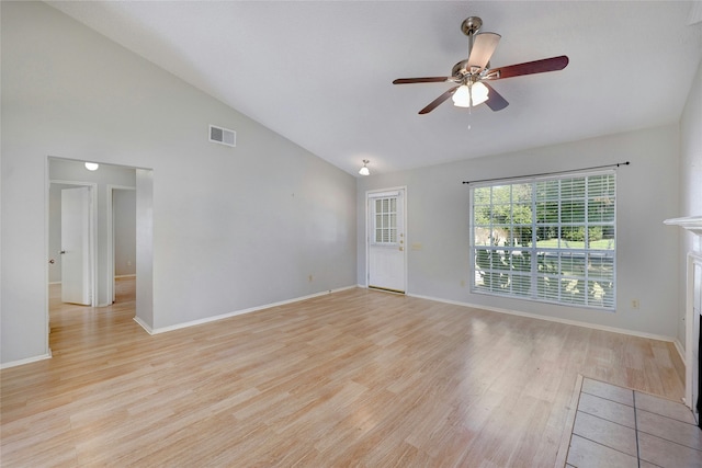 empty room featuring light hardwood / wood-style floors, ceiling fan, and vaulted ceiling