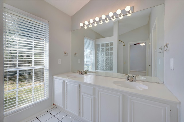 bathroom featuring vaulted ceiling, ceiling fan, tile patterned flooring, and plenty of natural light