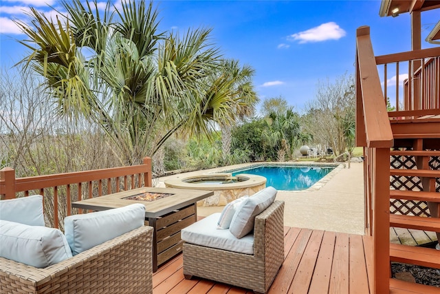 view of pool with an in ground hot tub, an outdoor fire pit, and a wooden deck