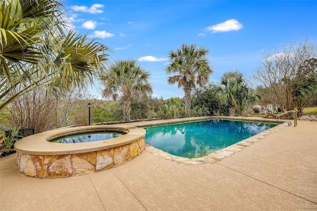 view of pool with a patio area and an in ground hot tub