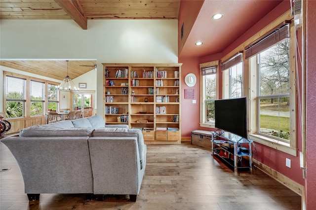 living room with hardwood / wood-style flooring, wooden ceiling, lofted ceiling with beams, and a chandelier