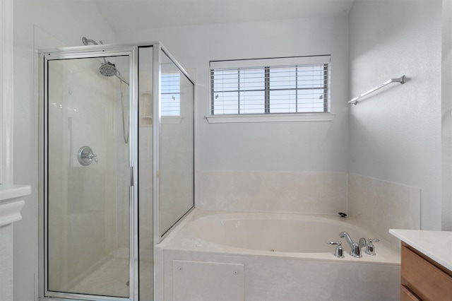 bathroom featuring plus walk in shower and vanity