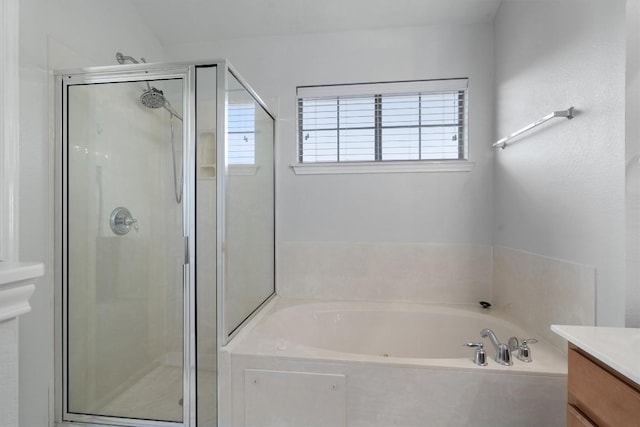 full bath featuring a stall shower, vanity, and a bath