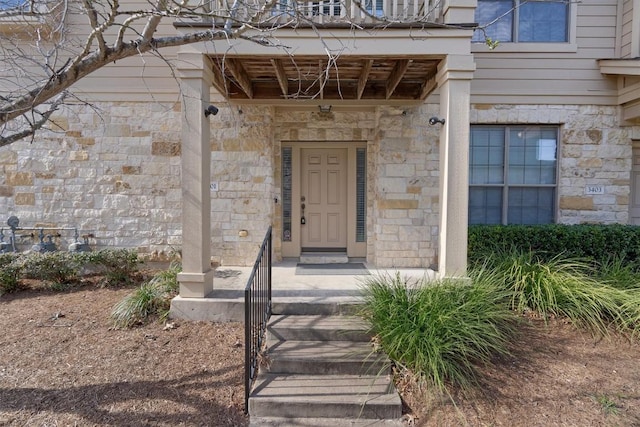 doorway to property featuring stone siding